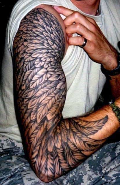 Arm with detailed feather tattoo sleeve