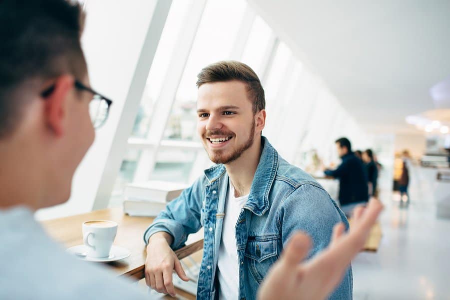men are sitting in front of the table