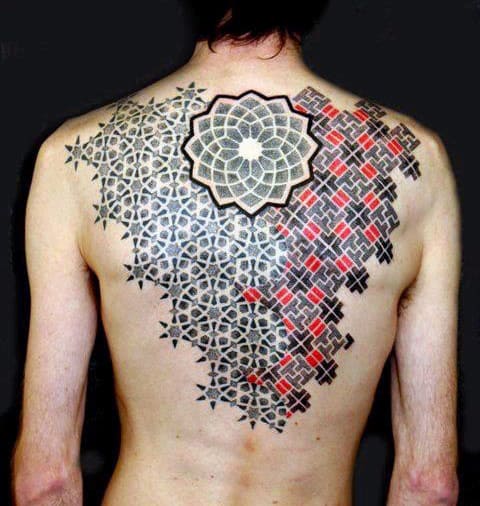 Intricate geometric tattoo covering a person's back with a mix of black and red patterns