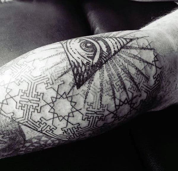 Black and grey geometric calf tattoo featuring the all-seeing eye within a triangle, surrounded by intricate patterns and dotwork shading