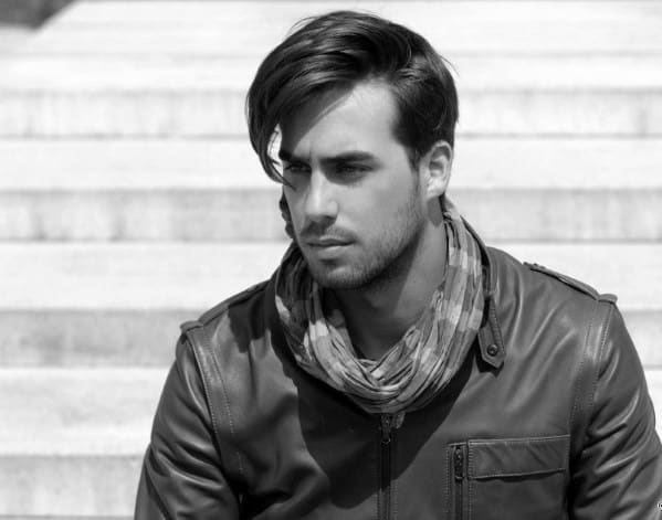 Medium-length, swept-over side part with a natural flow and volume