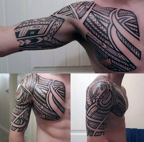 Intricate tribal tattoo covering a man's arm and shoulder in black ink