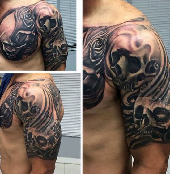 Close-up of a person's arm and shoulder with a detailed skull and smoke tattoo design