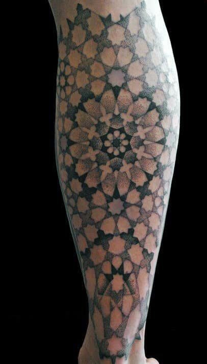 Intricate geometric tattoo covering an arm with detailed symmetrical patterns
