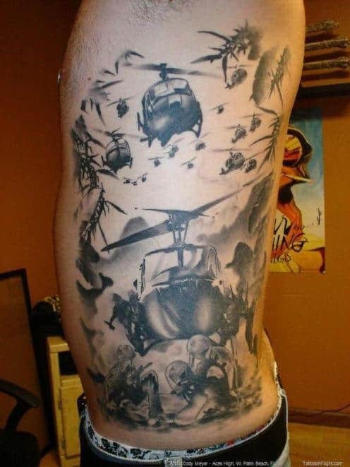 Tattoo of helicopters and soldiers in action on a person's side torso