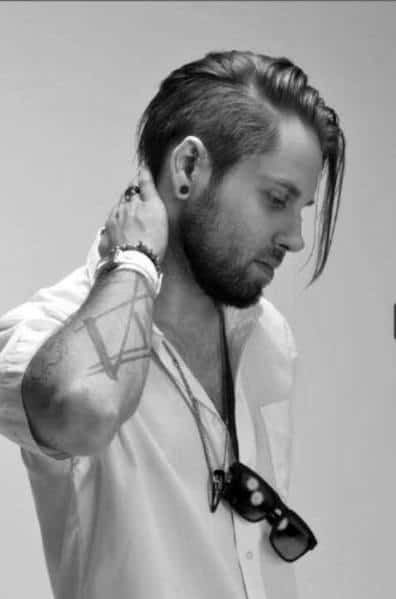 Undercut with long, textured hair swept to the side