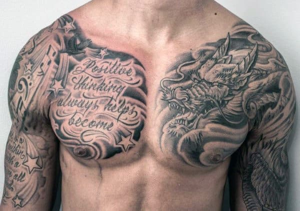 Close-up of a man's chest tattoos featuring a dragon and inspirational text