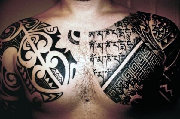 Man's chest and shoulders with intricate black tribal tattoos on both sides