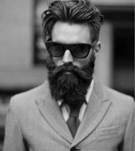 Man with voluminous, styled hair and a full beard