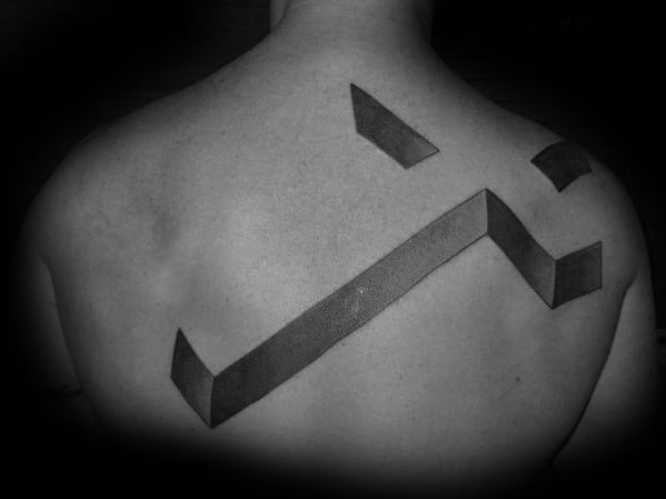 Monochrome tattoo of abstract geometric shapes on a person's back