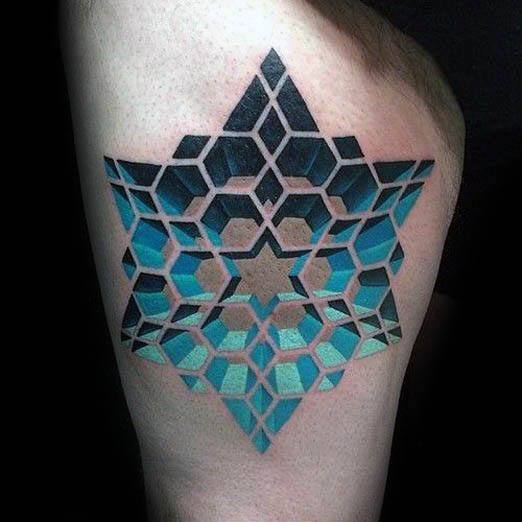 Geometric star tattoo with 3D cube illusion in shades of black, blue, and teal, forming a symmetrical, futuristic design on the upper arm.