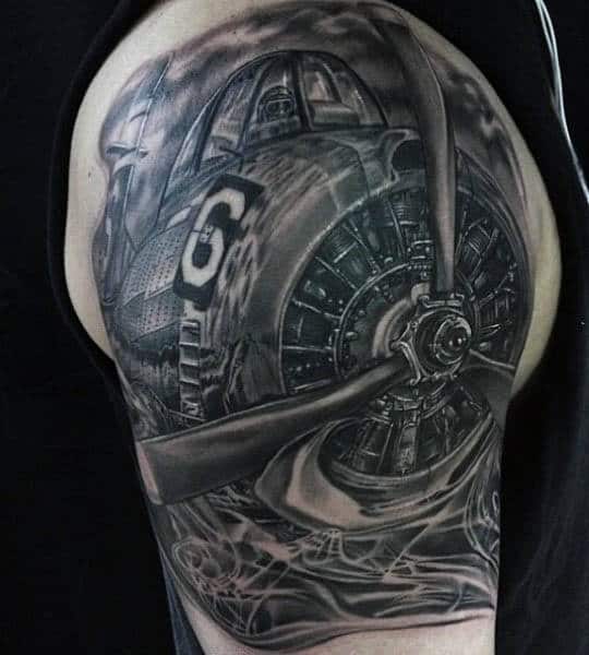 Tattoo of a vintage airplane propeller on an arm with intricate details capturing the essence of aviation history