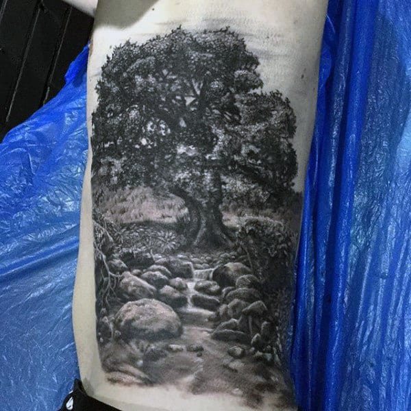 Mens Amazing Pencil Art Oak Tree And Stream Tattoo On Side Ribs