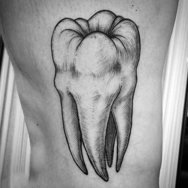 Black ink tattoo of a detailed molar tooth on the side torso, featuring fine lines and shading for a classic anatomical look.
