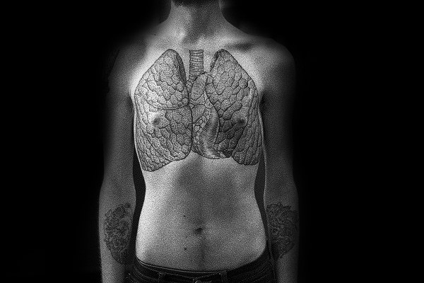 Detailed chest tattoo of lungs with intricate vein patterns, extending symmetrically across the upper torso in a dotwork style.