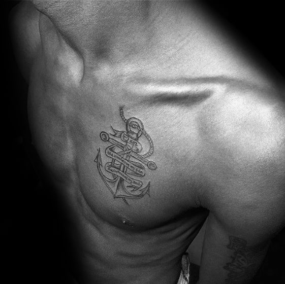 Realistic black and gray anchor tattoo on the chest with a wrapped rope and intricate shading, symbolizing strength, stability, and resilience.