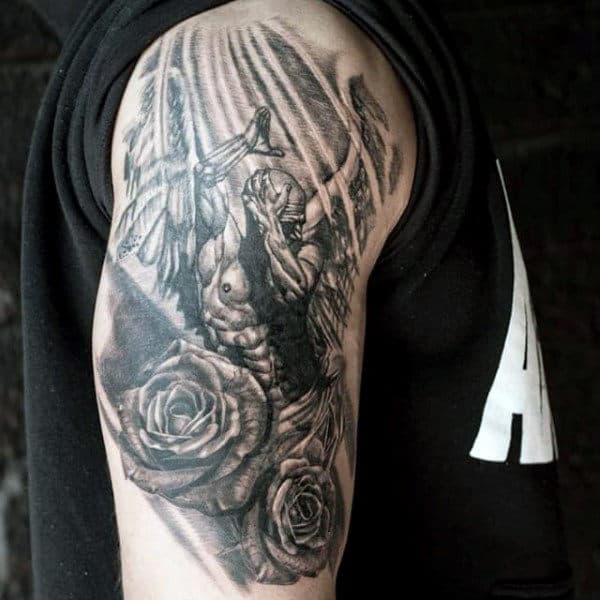 Detailed black and gray tattoo featuring roses and an angel,