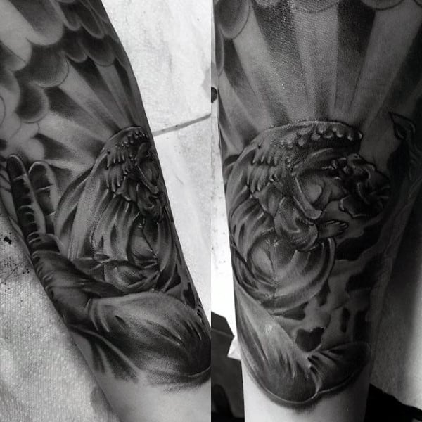 Black and gray tattoo of a roaring lion on a forearm with a cloudy backdrop