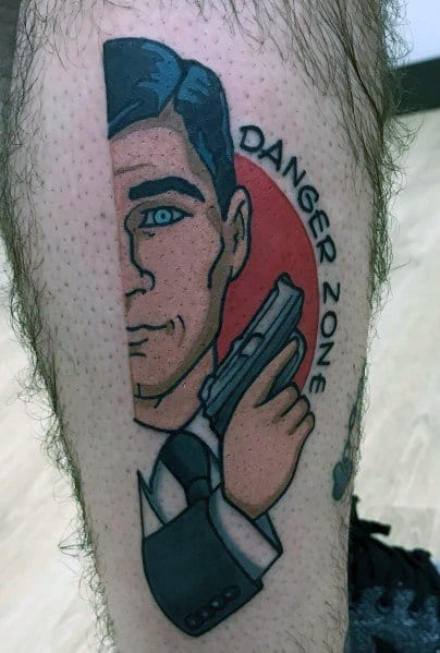 Stylized Archer tattoo featuring a half-face design, bold outlines, a red background, and 'Danger Zone' text curving around.