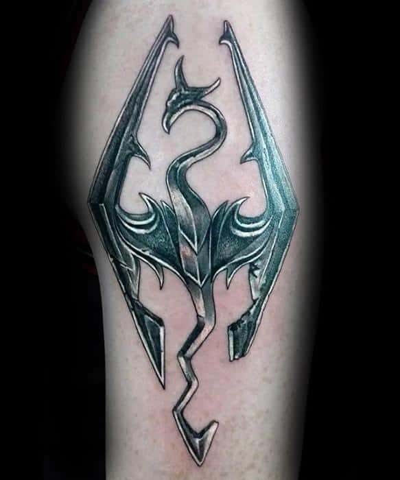Tattoo of a Skyrim-inspired dragon emblem with sharp, angular wings on skin