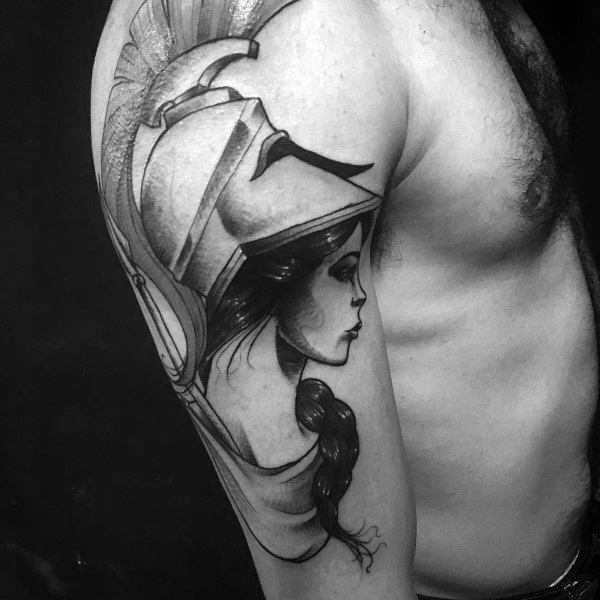 Athena tattoo on upper arm with a braided hairstyle, strong helmet design, and elegant profile in soft black and grey shading