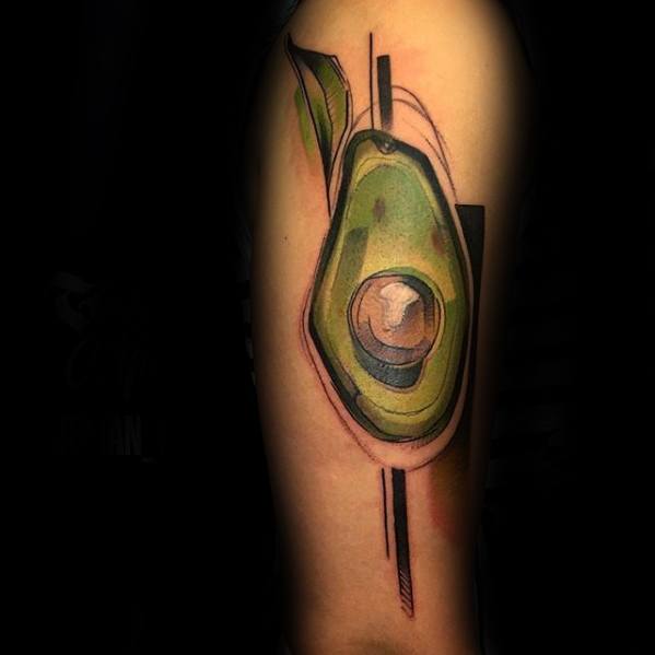 Abstract avocado tattoo on the upper arm, blending watercolor and geometric elements with bold lines and artistic shading.