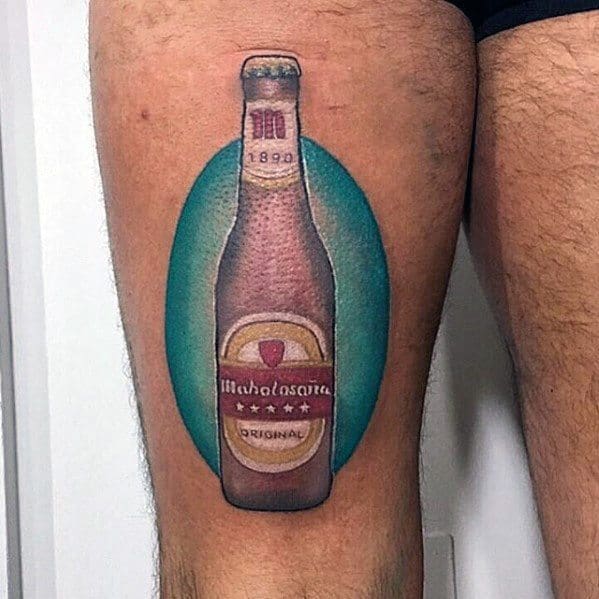 Colorful tattoo of a Mahou beer bottle with realistic shading and highlights, set against a teal oval background on the thigh for a bold visual pop.