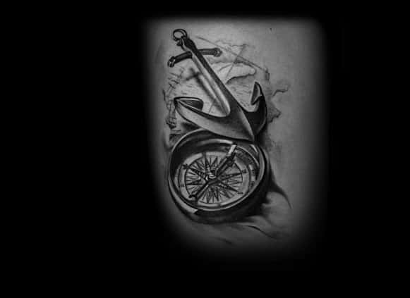 Tattoo of an anchor intertwined with a compass, set against a beautifully shaded background