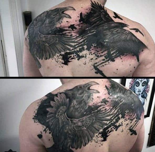 Back tattoo featuring realistic black crows with spread wings in flight on a man's back