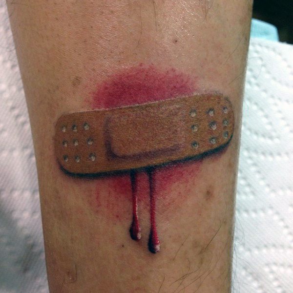 Hyper-realistic Band-Aid tattoo with red irritation and dripping blood detail, giving a dramatic and raw 3D effect.
