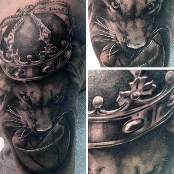 Crowned lion tattoo on the upper arm, detailed in black and gray ink