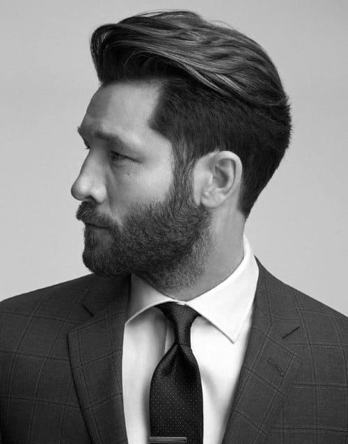 Man with a neatly styled haircut and a short beard