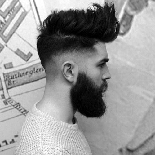 Man with a high fade and voluminous top, paired with a full beard