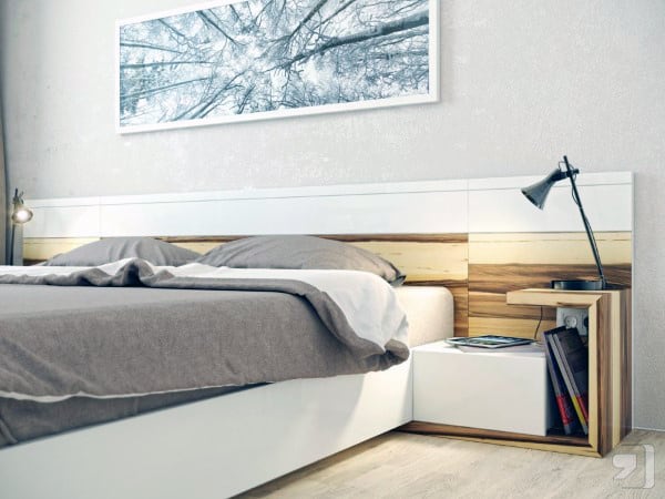 Bright bedroom with a wooden bed, bedside table, lamp, and a nature-themed wall art