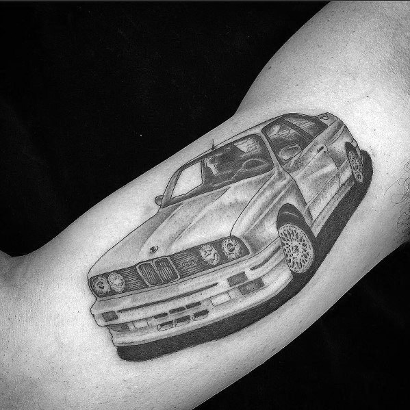 Realistic BMW E30 tattoo on arm, featuring detailed shading and a dynamic perspective for a bold automotive-inspired design.