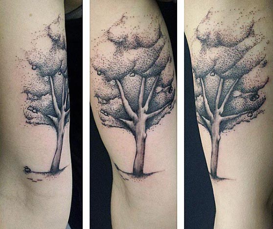 Black and grey dotwork tattoo of a tree on the inner bicep, featuring delicate shading and fine details for a natural, artistic look