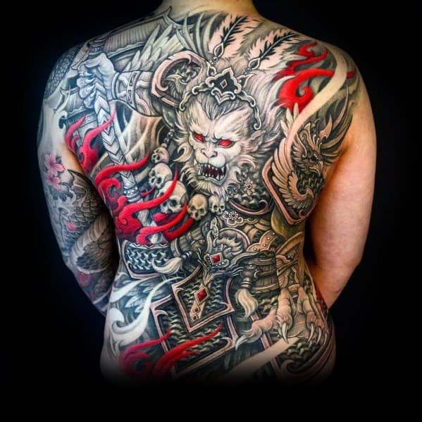 Large full-back tattoo featuring a fierce warrior demon with intricate armor, skulls, and bold red flame accents for a striking and powerful design.