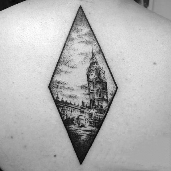 Detailed black and grey tattoo of Big Ben inside a diamond-shaped frame, showcasing intricate shading and architectural details on the back.