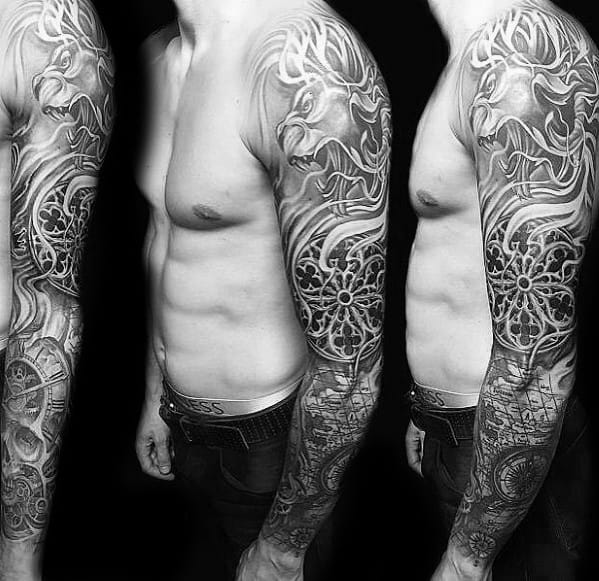 Black and grey full-sleeve tattoo featuring a roaring lion, intricate filigree patterns, and clock elements for a bold and dynamic design.