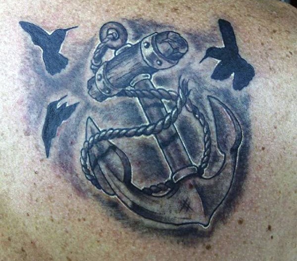 Tattoo of an anchor with rope and three birds in flight