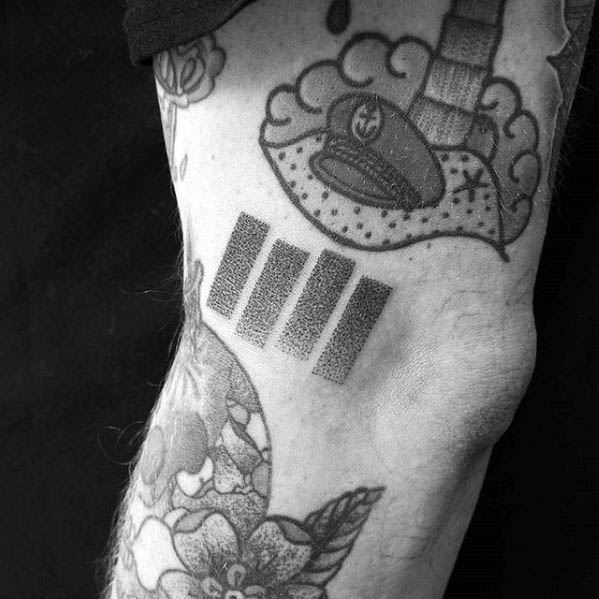Dotwork Black Flag bars tattooed near the elbow, using stippling for a textured look that blends punk style with artistic technique.