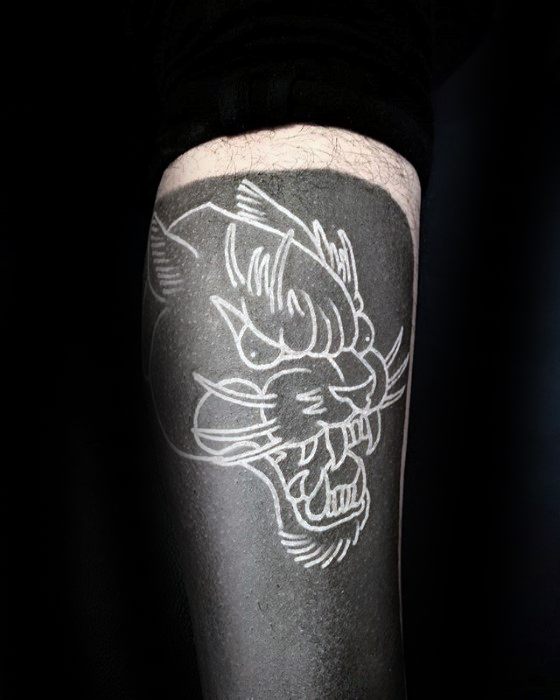 Blast over white ink lion tattoo on black background