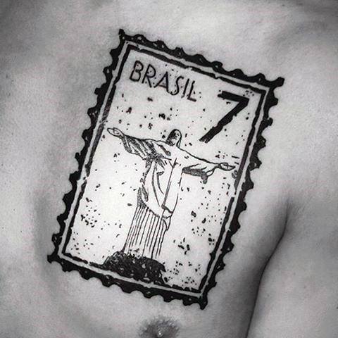 Tattoo of a Brazilian postage stamp featuring the iconic image of Christ the Redeemer alongside the number 7