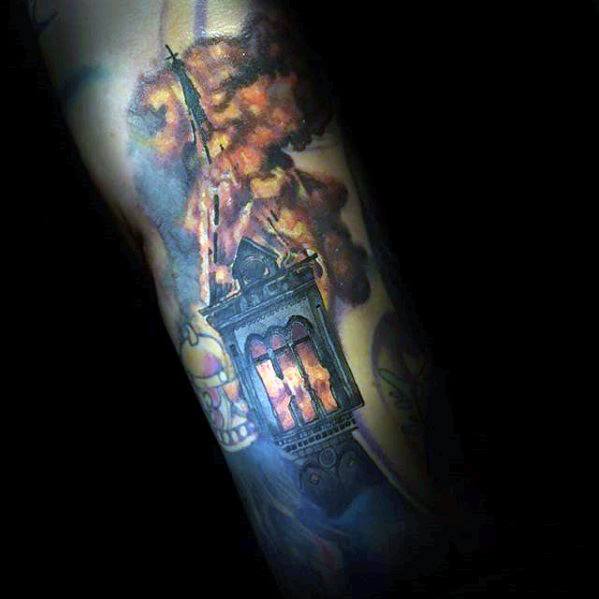 Realistic burning church tattoo with glowing stained glass windows and intense orange flames. Dark background adds depth and contrast.