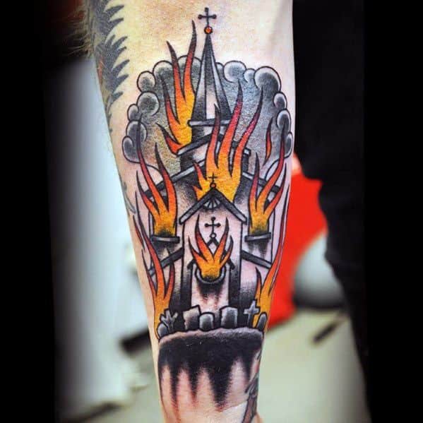 Traditional style tattoo of a burning church with bold black outlines, red and orange flames, and smoke clouds. Graveyard details at the base.