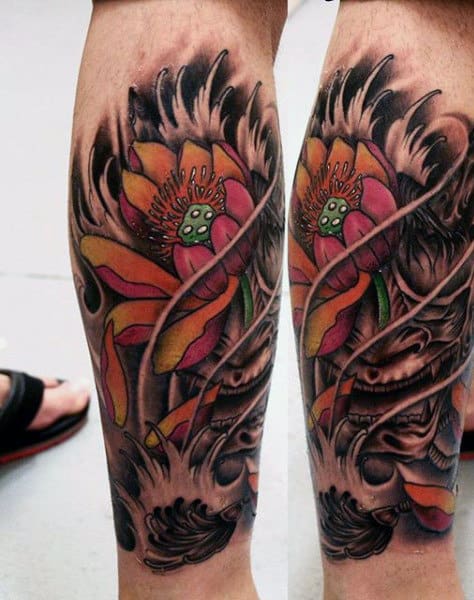 Colorful calf tattoo featuring a vibrant lotus flower with swirling black and grey shading, blending into a dynamic, abstract design