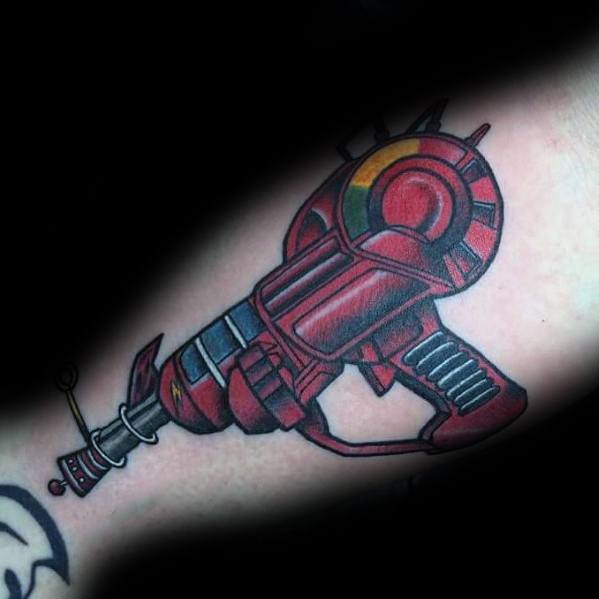 Bold Call of Duty Ray Gun tattoo featuring vibrant red and black details with futuristic design elements, creating a striking forearm piece.