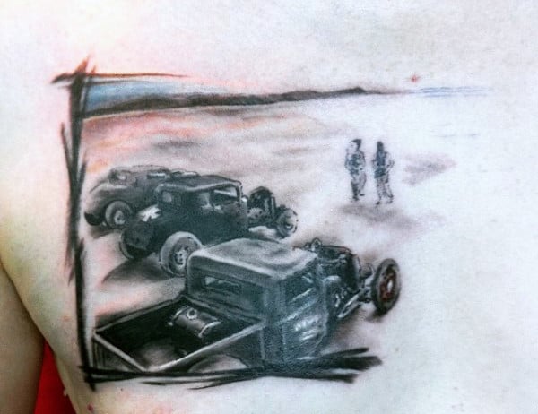 Tattoo featuring vintage cars on a road with two figures in the distance, framed by abstract lines