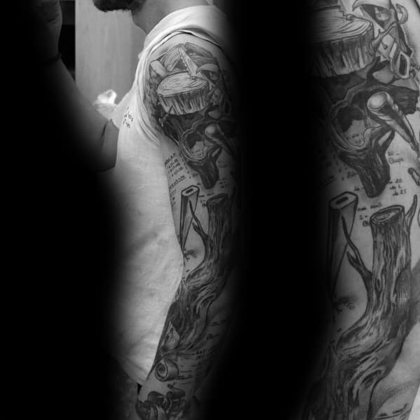 Black and gray tattoo sleeve featuring tree stumps, axes, and wood grain details, symbolizing craftsmanship, labor, and woodworking heritage.