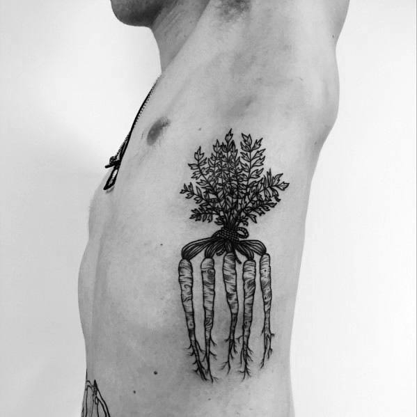 Black ink tattoo of multiple carrots tied together, featuring fine line detailing and intricate leafy tops for a bold and organic design.